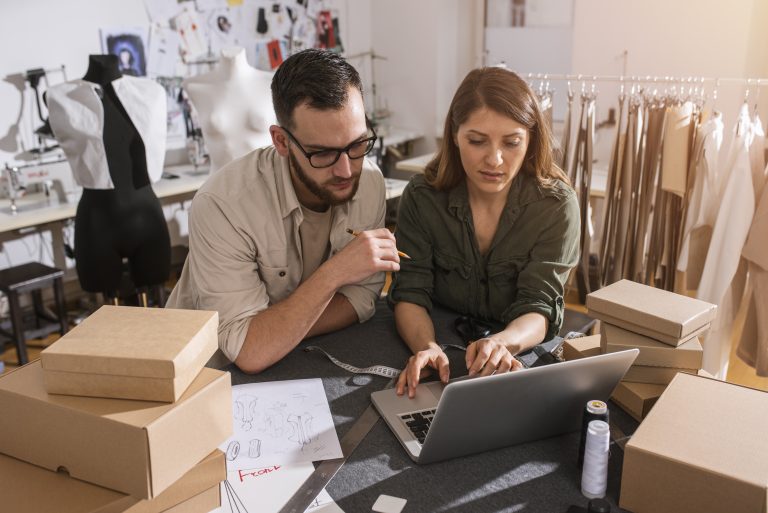 Seamstresses team ready to ship package to client with new clothes